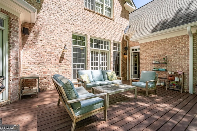 wooden deck with an outdoor living space
