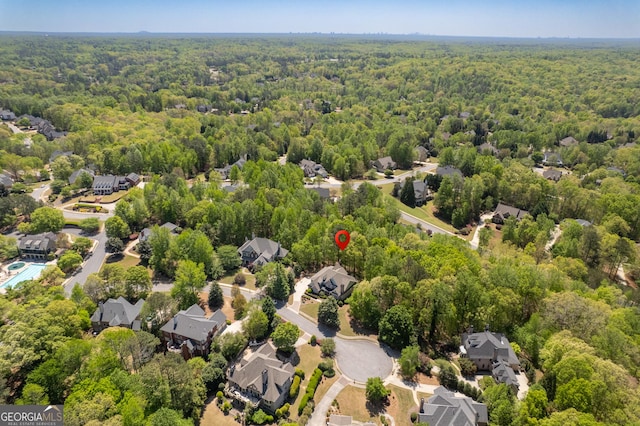 aerial view featuring a residential view and a wooded view