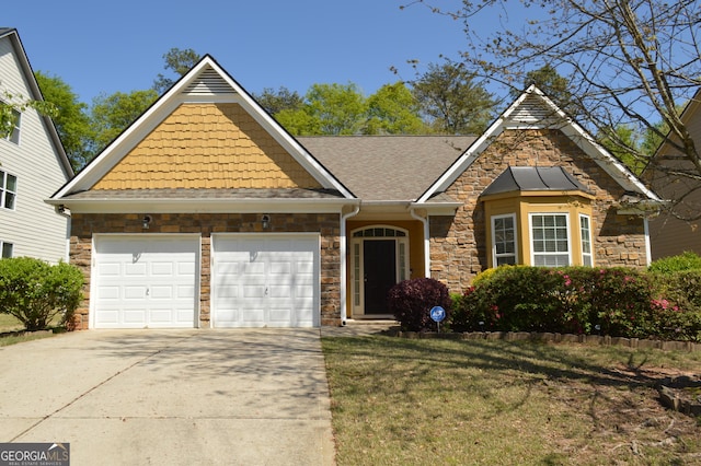 view of front facade featuring an attached garage, stone siding, driveway, and a front lawn