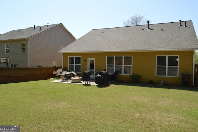 back of house featuring an outdoor fire pit, a patio, a yard, and fence
