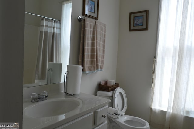 full bathroom with toilet, vanity, and a shower with curtain