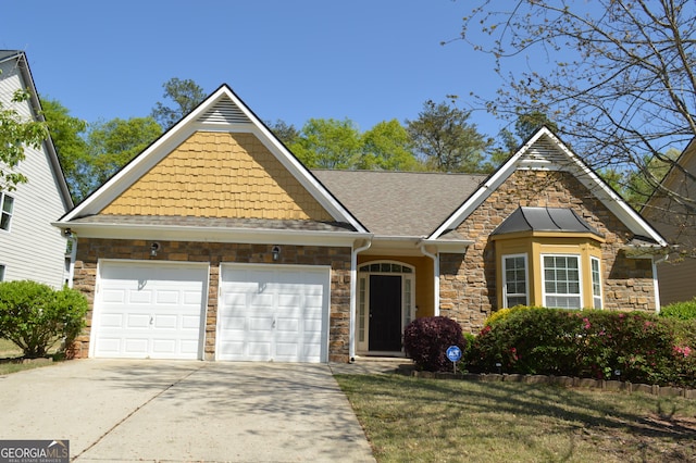 view of front of house featuring concrete driveway, stone siding, and an attached garage