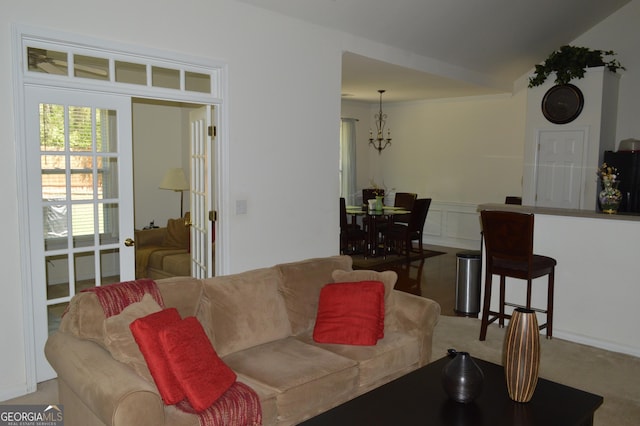 living room featuring carpet flooring and a notable chandelier