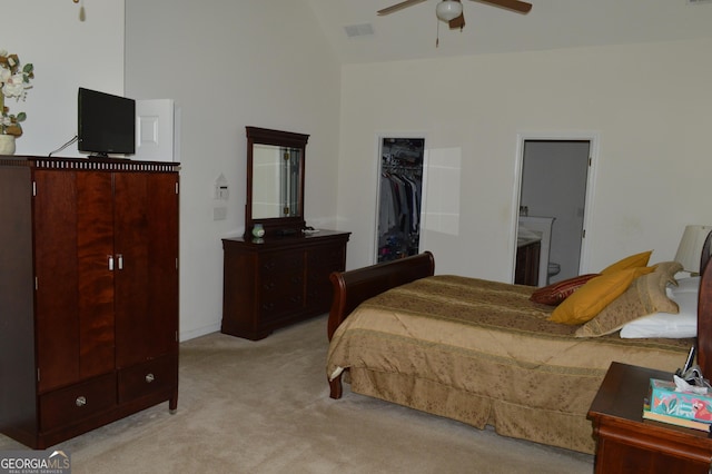 bedroom featuring high vaulted ceiling, a closet, visible vents, carpet flooring, and a walk in closet