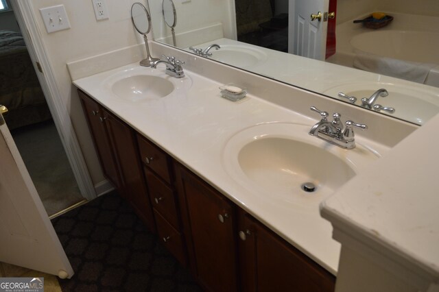 full bathroom featuring double vanity and a sink