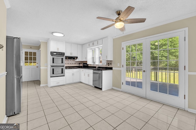 kitchen featuring stainless steel appliances, crown molding, a textured ceiling, ceiling fan, and white cabinets