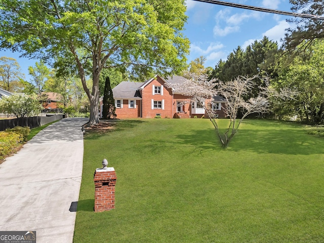 view of front of property with driveway and brick siding