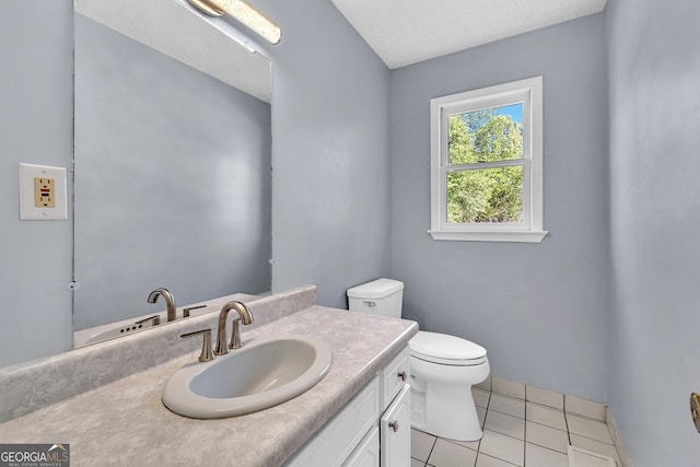 half bath with tile patterned floors, toilet, and vanity