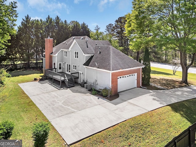 view of property exterior featuring an attached garage, driveway, central AC unit, brick siding, and a chimney