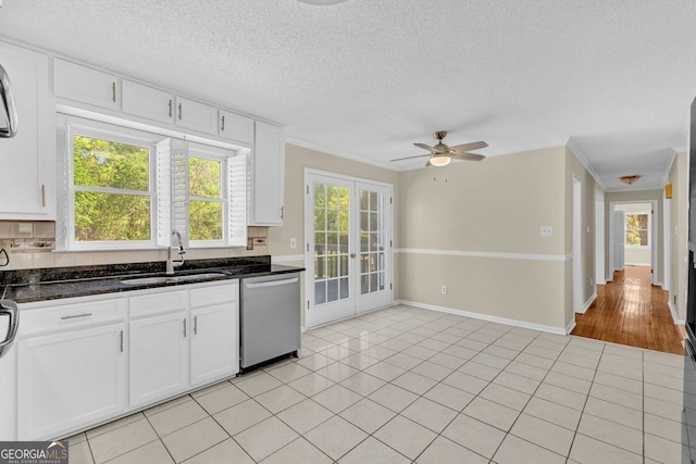 kitchen with dishwasher, a sink, french doors, white cabinets, and ornamental molding