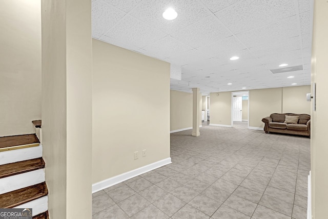finished below grade area with stairs, baseboards, and recessed lighting