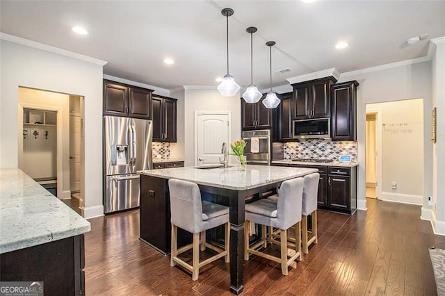 1190 Mosspointe Dr, Roswell, GA 30075 - kitchen with stainless steel appliances, a sink, decorative backsplash, light stone counters, and ornamental molding