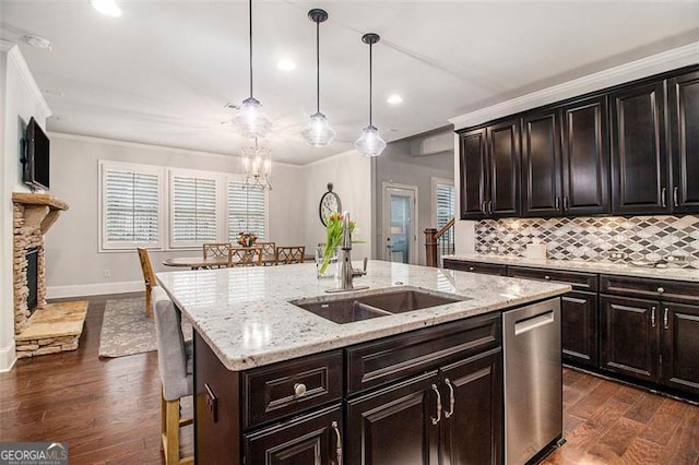 1190 Mosspointe Dr, Roswell, GA 30075 - kitchen featuring stainless steel dishwasher, ornamental molding, a sink, dark wood-style floors, and a center island with sink
