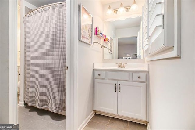 1190 Mosspointe Dr, Roswell, GA 30075 - bathroom featuring tile patterned flooring, vanity, a shower with shower curtain, and baseboards