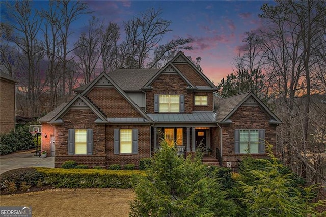 1190 Mosspointe Dr, Roswell, GA 30075 - craftsman house featuring stone siding, a porch, a standing seam roof, and brick siding