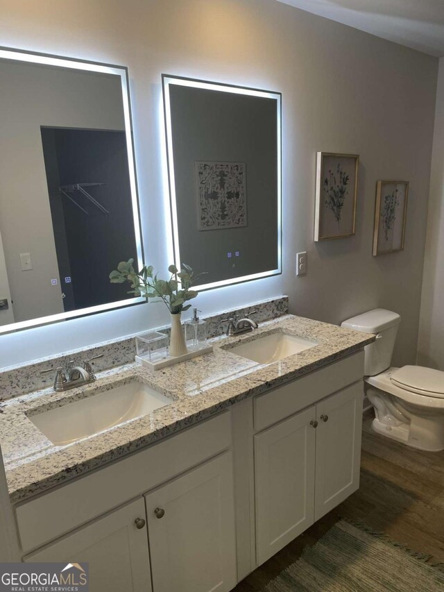 736 Great Oak Pl Unit 10, Villa Rica, GA 30180 - full bathroom with double vanity, wood finished floors, toilet, and a sink