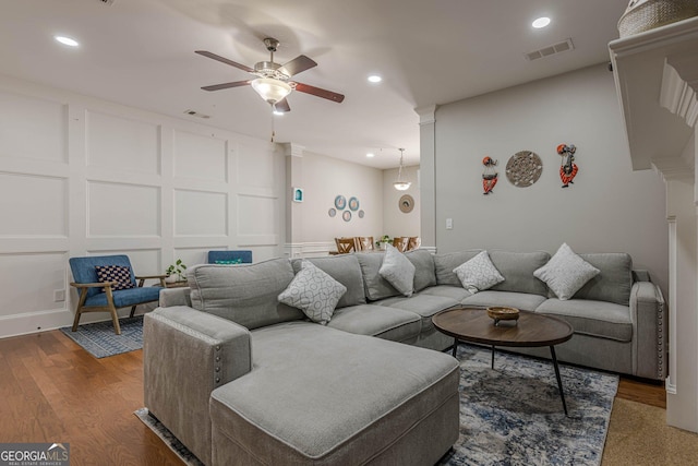 2705 Maple Park Pl Unit 29, Cumming, GA 30041 - living room featuring visible vents, wood finished floors, ceiling fan, and a decorative wall