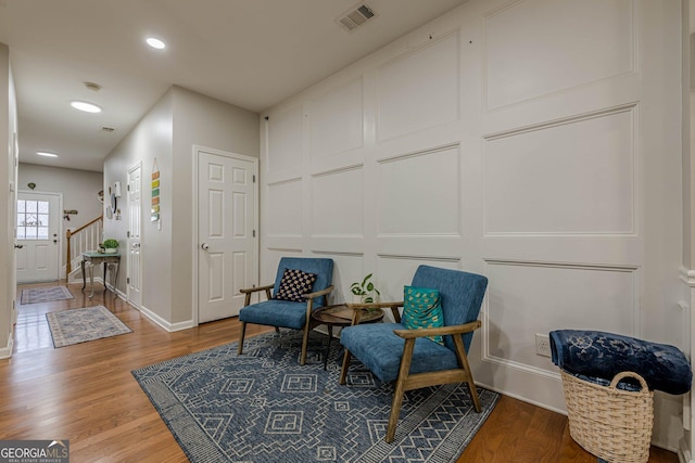 2705 Maple Park Pl Unit 29, Cumming, GA 30041 - living area with a decorative wall, visible vents, baseboards, wood finished floors, and recessed lighting
