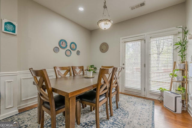 2705 Maple Park Pl Unit 29, Cumming, GA 30041 - dining area with a decorative wall, a wainscoted wall, light wood finished floors, and visible vents