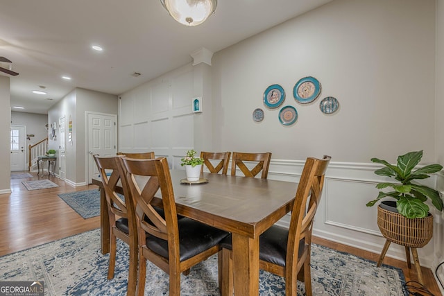 2705 Maple Park Pl Unit 29, Cumming, GA 30041 - dining area with a decorative wall, stairs, wood finished floors, recessed lighting, and wainscoting