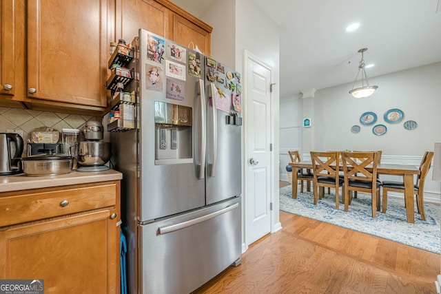 2705 Maple Park Pl Unit 29, Cumming, GA 30041 - kitchen featuring brown cabinets, backsplash, light wood-style flooring, and stainless steel fridge