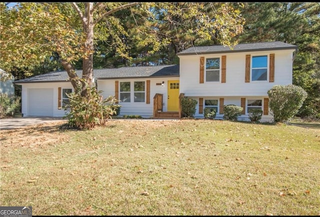 tri-level home with a front lawn, driveway, and a garage