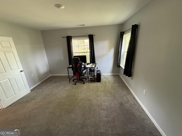 carpeted office space with visible vents and baseboards