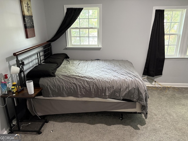 carpeted bedroom featuring multiple windows