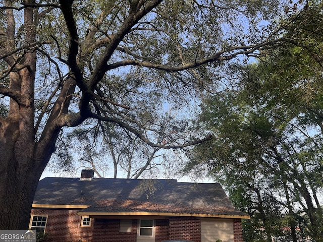 details featuring a chimney and brick siding
