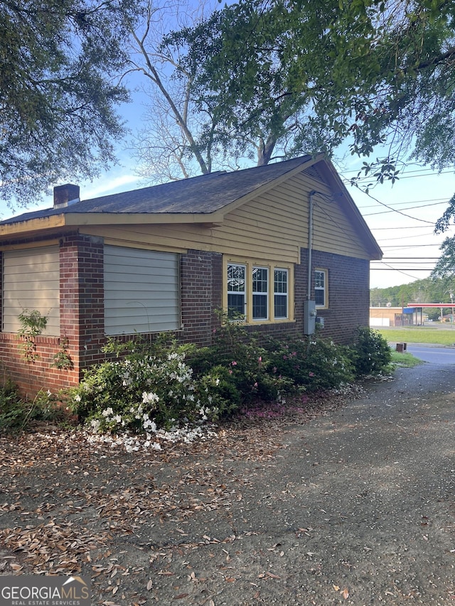 view of home's exterior with brick siding