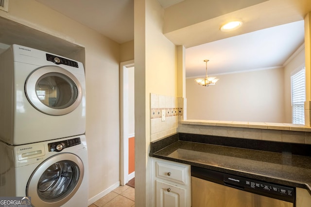 177 Amherst Pl NW, Atlanta, GA 30327 - clothes washing area with crown molding, stacked washer / drying machine, a chandelier, laundry area, and light tile patterned floors