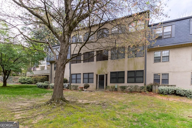 177 Amherst Pl NW, Atlanta, GA 30327 - rear view of property with stucco siding and a lawn