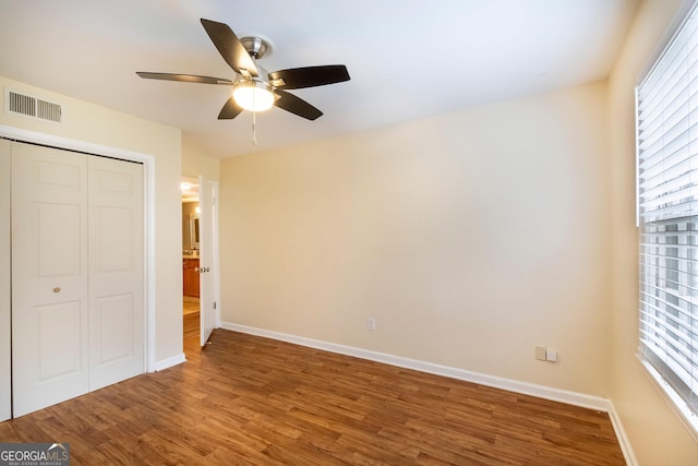 177 Amherst Pl NW, Atlanta, GA 30327 - unfurnished bedroom featuring a closet, wood finished floors, baseboards, visible vents, and ceiling fan