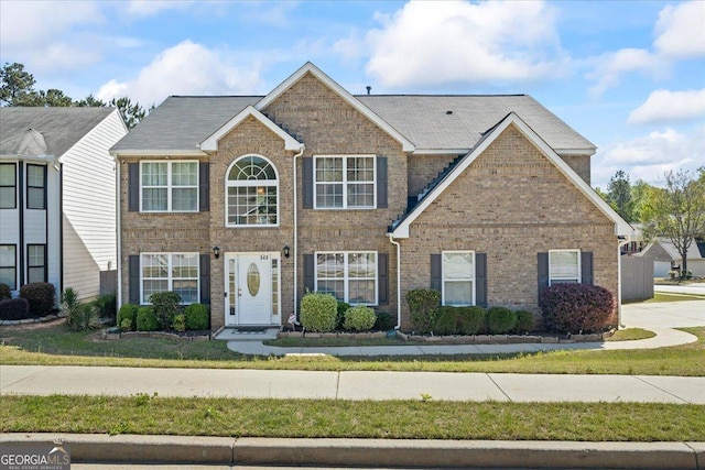 colonial house featuring brick siding