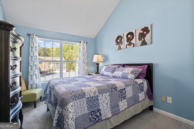 bedroom featuring baseboards, lofted ceiling, and carpet