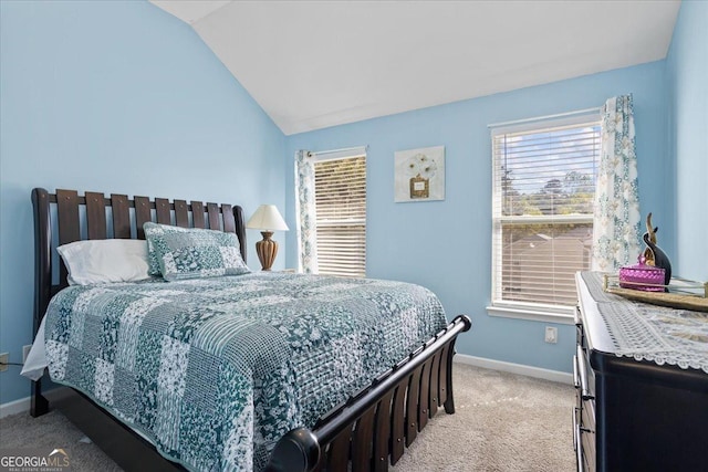 bedroom with light colored carpet, baseboards, and vaulted ceiling