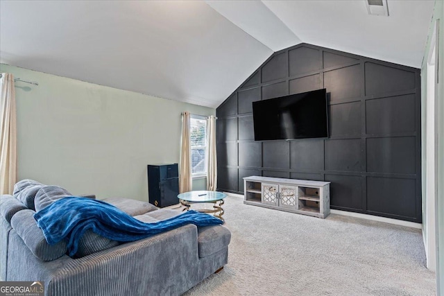 carpeted living area featuring lofted ceiling, a decorative wall, and visible vents