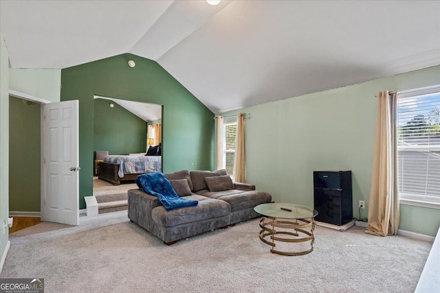 living room with lofted ceiling, carpet flooring, and a wealth of natural light