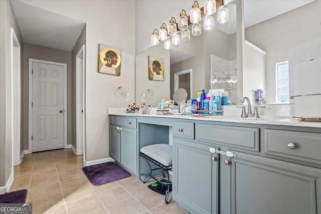 bathroom with baseboards, a sink, and double vanity