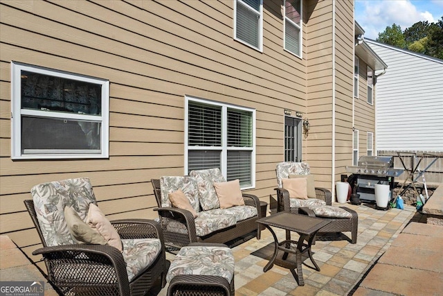 view of patio / terrace with fence, outdoor lounge area, and a grill