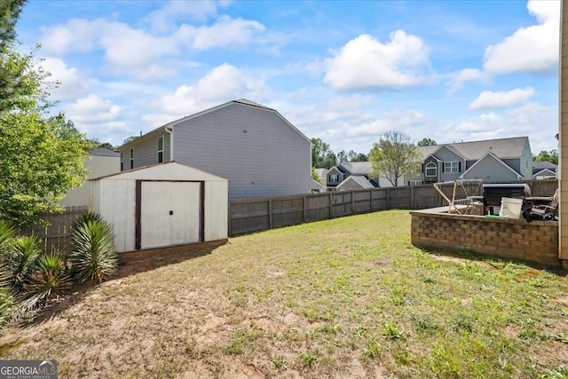 view of yard featuring a fenced backyard, an outdoor structure, a hot tub, and a storage shed