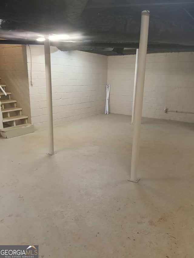 unfinished below grade area featuring stairs