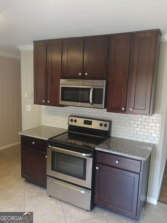 kitchen featuring crown molding, stainless steel appliances, dark brown cabinets, stone countertops, and backsplash