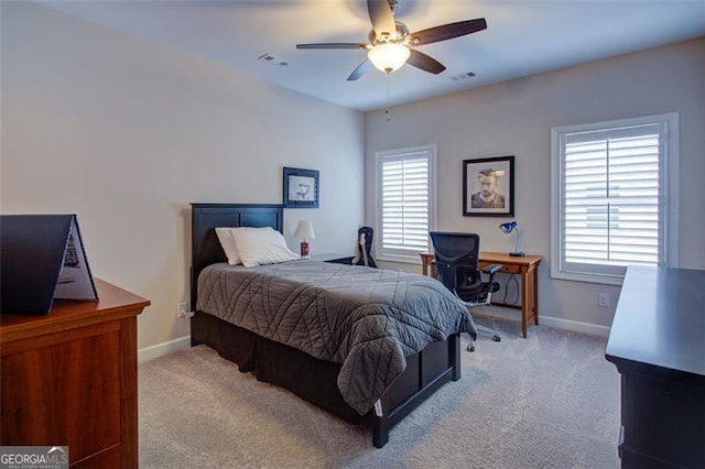 carpeted bedroom with visible vents, baseboards, and multiple windows