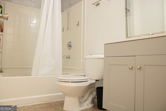 full bath with toilet, vanity, tile patterned flooring, and shower / tub combo