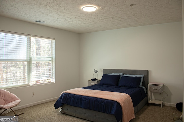 bedroom featuring multiple windows, visible vents, baseboards, and carpet flooring