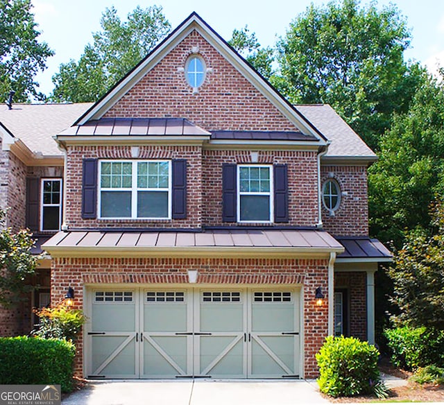 view of front of home featuring an attached garage and brick siding