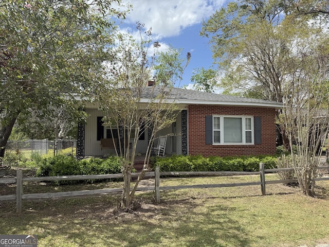 view of front of house with an attached carport, a front yard, fence, and brick siding