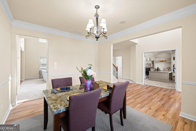 2694 Dawning Day Dr, Dacula, GA 30019 - dining space featuring baseboards, ornamental molding, light wood-type flooring, and a notable chandelier