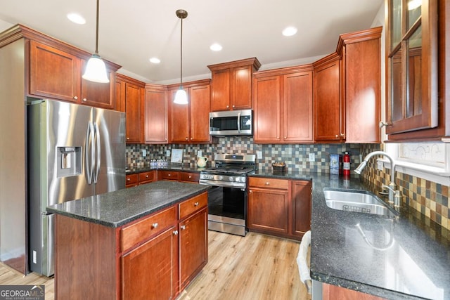 2694 Dawning Day Dr, Dacula, GA 30019 - kitchen featuring a sink, light wood-style flooring, stainless steel appliances, backsplash, and pendant lighting